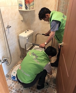 홀몸 어르신 안전사고 예방을 위해 화장실에 안전바를 설치하고 있는 모습. (사진=국민연금 부산본부)