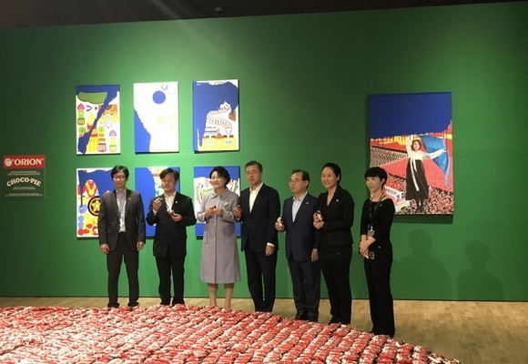 문재인 대통령 내외와 오거돈 부산시장 등 내빈들이 '초코파이 함께 먹어요'라는 작품 앞에서 직접 초코파이를 손에 들고 먹고 있는 모습. (사진=부산시)