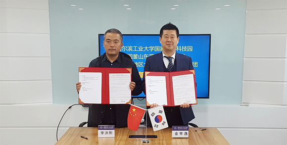 (왼쪽부터)이홍강 중국 하얼빈공업대학 국가대학과학기술원 국장과 김재일 동아대 창업지원단장이 업무협약을 맺고 기념 촬영을 하고 있다. (사진제공=동아대)